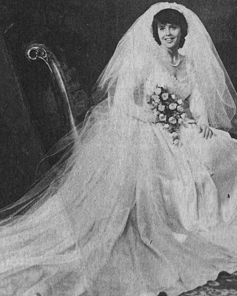 old newspaper clipping image of bride in bridal gown with veil and bouquet and train